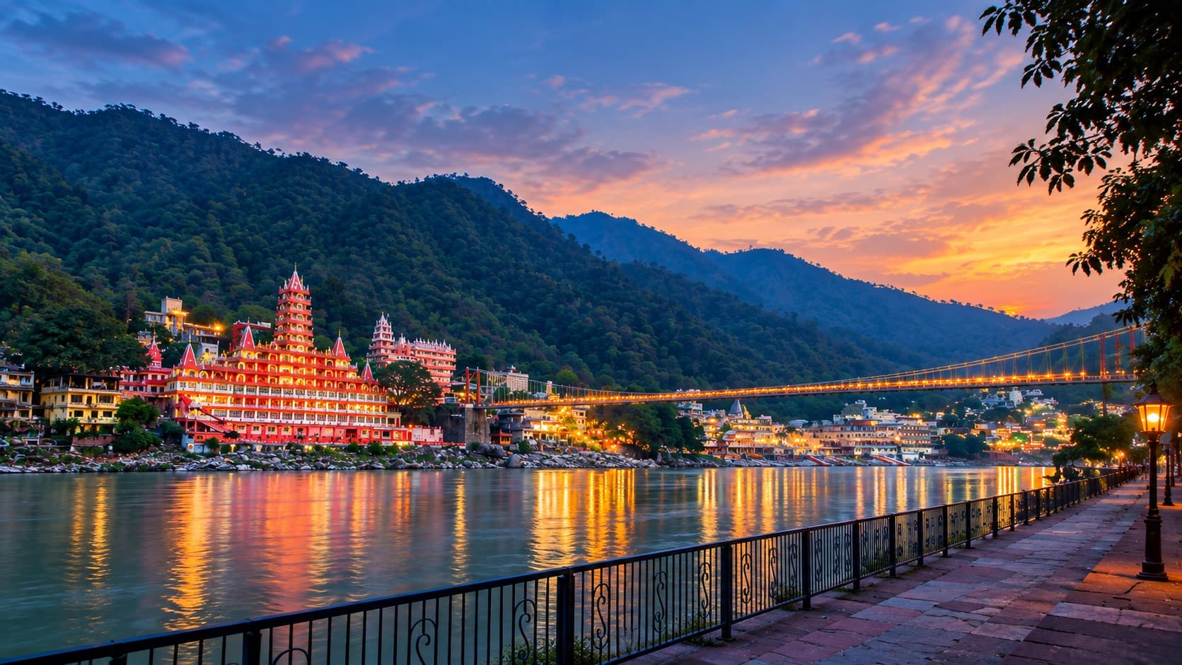 Sunset over the Ganga in Rishikesh, with the illuminated Ram Jhula bridge